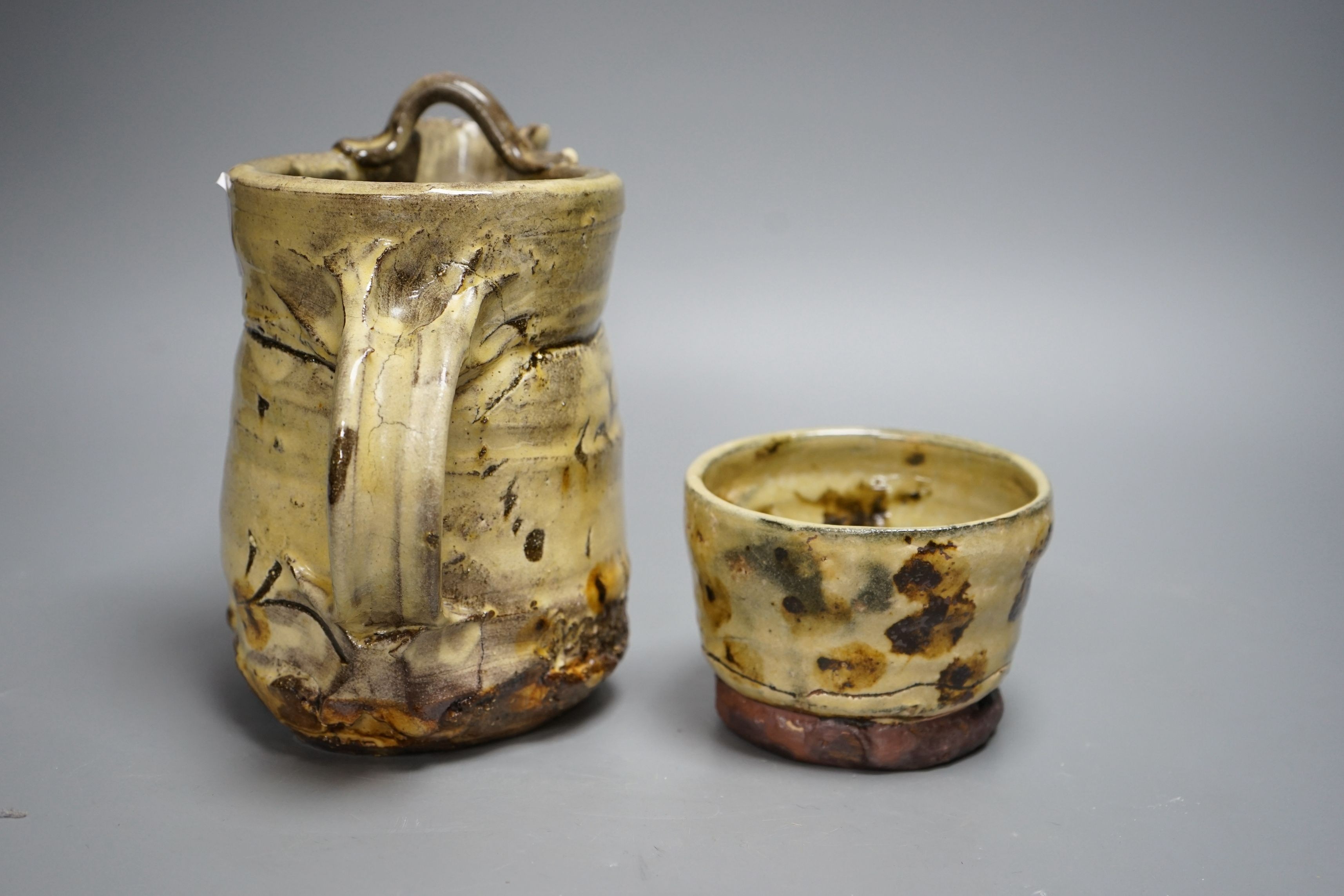 Jean-Nicolas Gérard (b.1954), a pale yellow and brown glazed earthenware jug and a similar bowl, with purchase receipt from Goldmark Gallery dated 09/04/2014, tallest 19.5cm, (2)